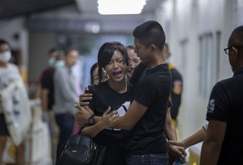 Relatives of a victim of a mass shooting react after visiting a morgue, in Korat, Nakhon Ratchasima, Thailand