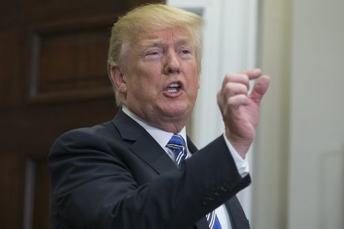 US President Donald Trump responds to a question from a member of the news media after signing a presidential proclamation on steel and aluminum tariffs. (AAP)