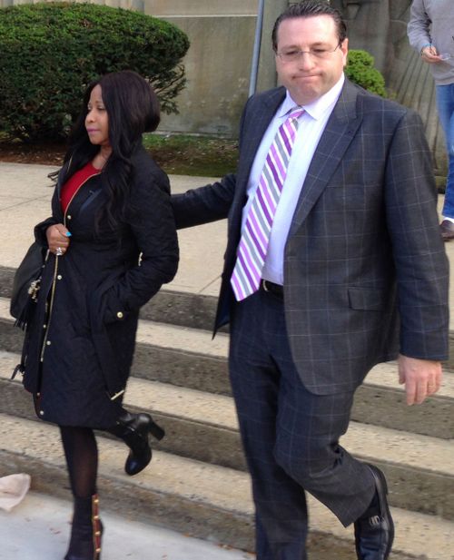 Maraj's mother is led out of the courthouse by his defence attorney (Image: AP)