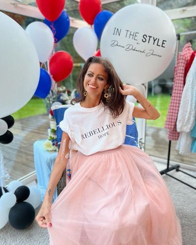 Dame Deborah James models the Rebellious Hope t-shirt from her In The Style collection, raising funds for the Bowel Babe Fund