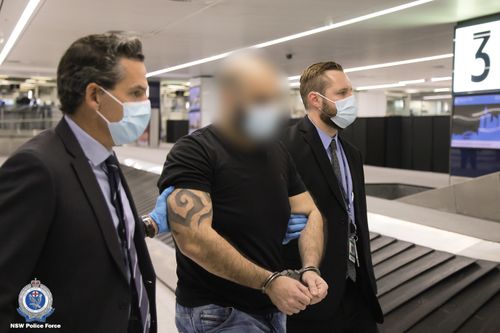 The pair landed at Sydney International Airport last night escorted by detectives. 