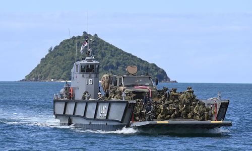 An Australian Navy landing craft is seen bringing troops and vehicles ashore as part of a amphibious landing rehearsal on July 15, 2025 in Cowley Beach, Australia. 
