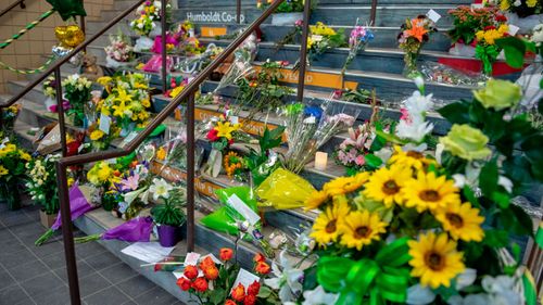 A memorial sits at the stairs that lead to Elgar Petersen Arena in Humboldt, Saskatchewan for the Broncos players killed. (AP).