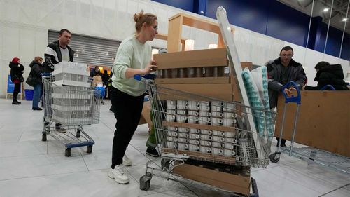 A woman in St Petersburg stocks up on coffee cups at IKEA.