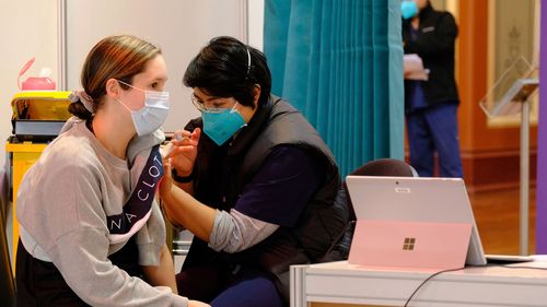 Medical staff and patients at the Royal Exhibition Building Vaccination Hub in Melbourne.