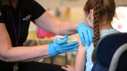 A nurse administers a pediatric dose of the Covid-19 vaccine to a girl at a L.A. Care Health Plan vaccination clinic at Los Angeles Mission College in the Sylmar neighborhood in Los Angeles, California, January 19, 2022 