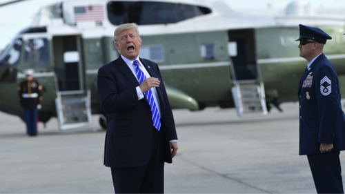 President Donald Trump responds to a reporter's question on health care Air after arriving at John F. Kennedy International Airport in New York.