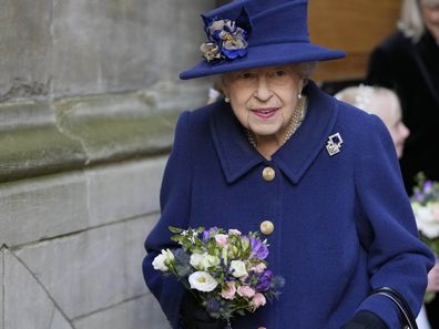 Britain's Queen Elizabeth II, Patron, holds flowers as she leaves after attending a Service of Thanksgiving to mark the Centenary of the Royal British Legion at Westminster Abbey, in London, Tuesday, Oct. 12, 2021. (AP Photo/Frank Augstein, Pool)