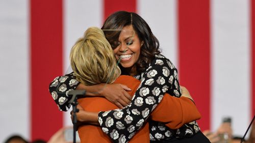 Democratic presidential candidate Hillary Clinton (L) and US First Lady Michelle Obama (R) hug during a presidential campaign event on October 27, 2016. (AFP)