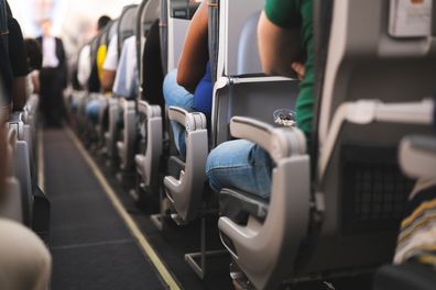 Passengers seated on a commercial flight.