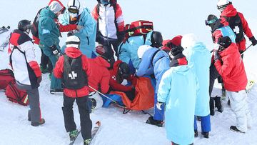 Rina Yoshika of Team Japan receives medical attention after crashing during the Snowboard Slopestyle Training session