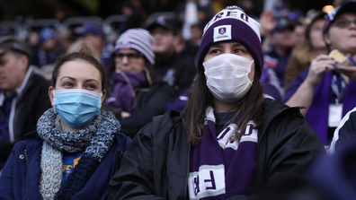 Spectators look on wearing face masks during the round 7 AFL match between the Fremantle Dockers and the West Coast Eagles at Optus Stadium on July 19, 2020 in Perth, Australia. (Photo by Paul Kane/Getty Images)