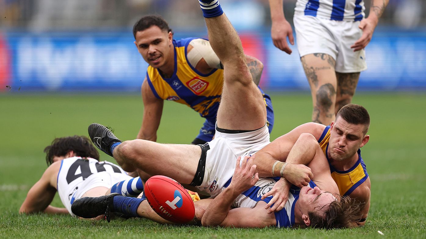 Elliot Yeo of the Eagles tackles George Wardlaw of the Kangaroos during the round 13 AFL match between West Coast Eagles and North Melbourne Kangaroos at Optus Stadium, on June 08, 2024, in Perth, Australia. (Photo by Paul Kane/Getty Images)