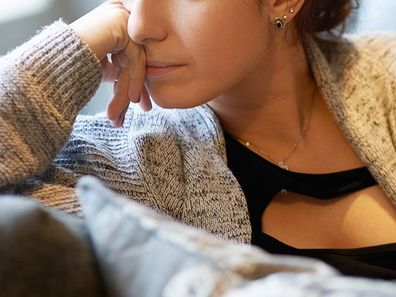 Shot of a young woman looking despondent after a fight with her boyfriend