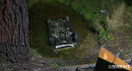 The car rolled into a creek after the impact. (9NEWS)