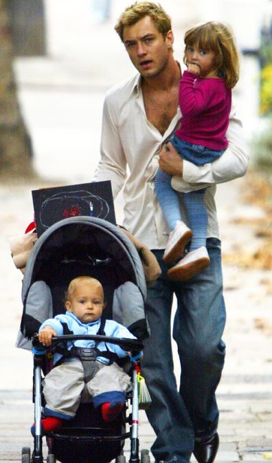 Jude Law walks with Rudy in pram and Iris in North London in October 2003.