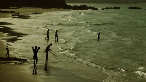 Wategoes. Surfers at Wategoes beach at Byron Bay on the NSW North Coast. 14 December 2005. AFR Photo by Andrew Quilty. Generic  surf, surfer, surfing, longboard, corporate, baby boomers, holiday, coast, property, coastal property, byron bay, weather, storm, relax, skin cancer, melanoma, beach, wategoes beach.