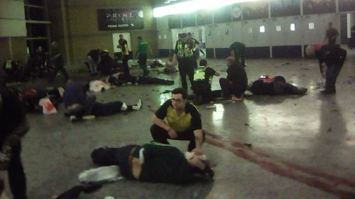 Helpers attend to injured people inside the Manchester Arena in 2017. (AAP)