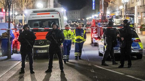 Police stand guard after a massacre in Hanau, Germany.