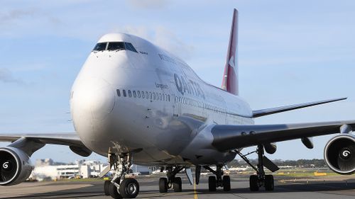 Qantas jet lands.