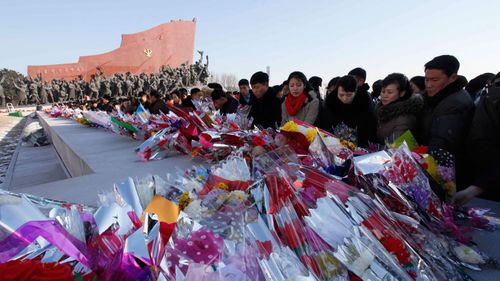 People offer flowers to the bronze statues of their late leaders Kim Il Sung and Kim Jong Il at Mansu Hill. (AP)
