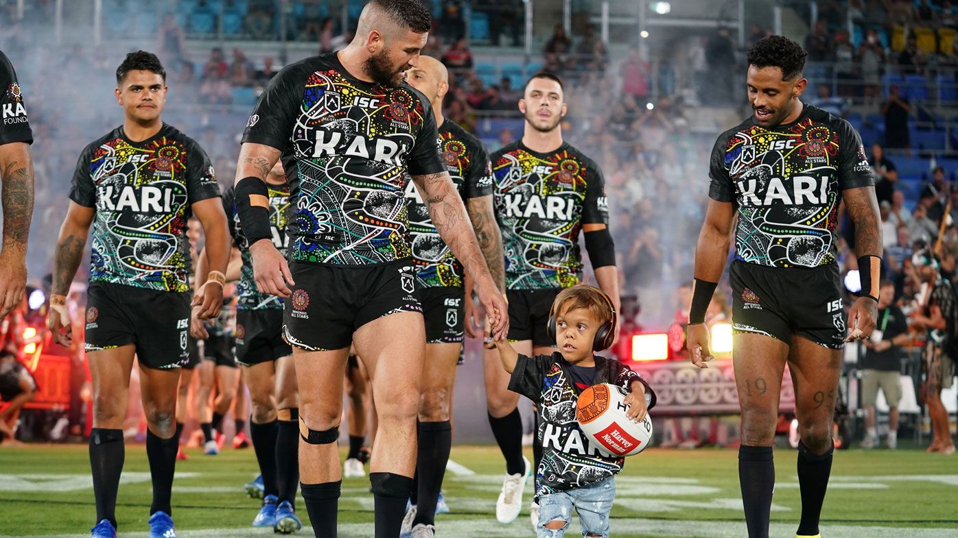 Quaden Bayles, (9), leads the Indigenous All Stars on to the field with captain Joel Thompson prior to the NRL Indigenous All-Stars vs Maori Kiwis match at CBus Super Stadium on the Gold Coast, Saturday, February 22, 2020.