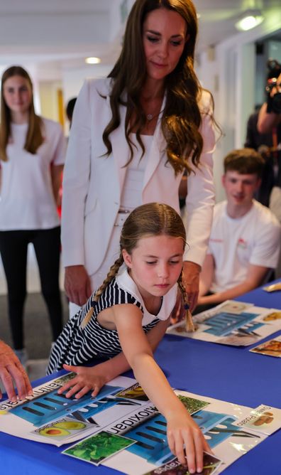 Catherine, Duchess of Cambridge and Princess Charlotte of Cambridge take part in an interactive learning experience during a visit to SportsAid House at the 2022 Commonwealth Games on August 02, 2022 in Birmingham, England. 