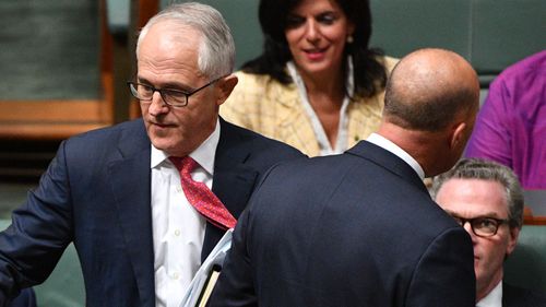 Malcolm Turnbull walking past Peter Dutton in Question Time.