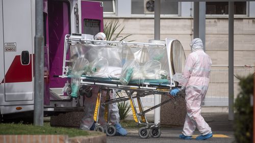 ROME, ITALY - MARCH 17: Medical staff collect a patient from an ambulance at the second Covid-19 hospital in the Columbus unit on March 17, 2020, in Rome, Italy. Italian Government continues to enfoce the nationwide lockdown measures to control the coronavirus spread. (Photo by Antonio Masiello/Getty Images)