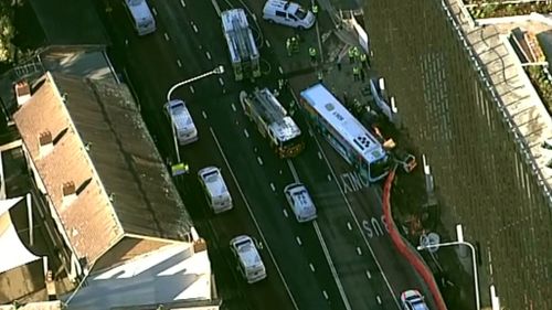 A bus and excavator crashed in Parramatta. (9NEWS)