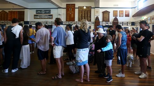 Members of the public queue to cast their vote at a polling centre