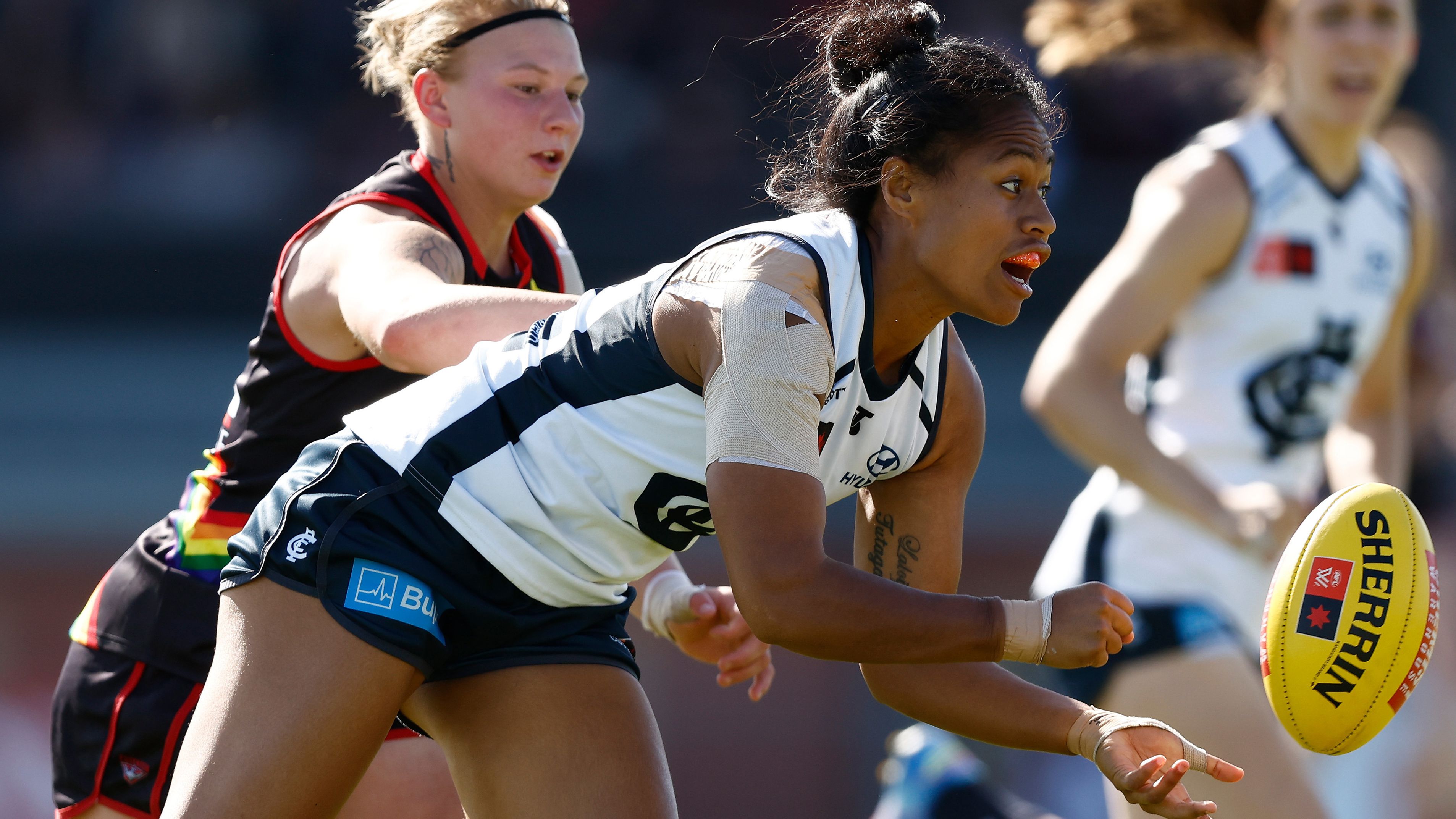 Vaomua Laloifi of the Blues is tackled by Paige Scott of the Bombers.