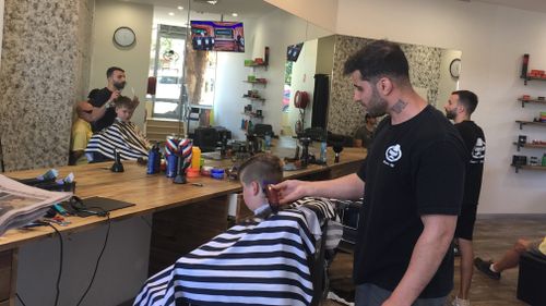 Sydney barber Sam Rahim will face the Human Rights and Equal Opportunity Commission after refusing to cut a young girl's hair. Picture: 9NEWS.