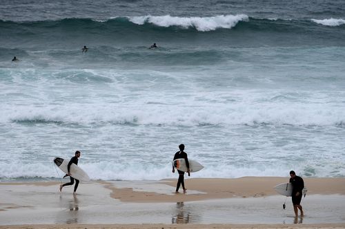 Currently, only soft-topped surfboards are allowed to be used anywhere on the beach, while hard-topped boards are restricted to the south. Picture: AAP.