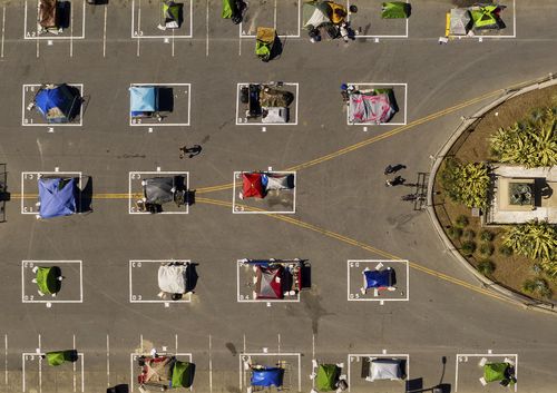 Rectangles designed to help prevent the spread of the coronavirus by encouraging social distancing line a city-sanctioned homeless encampment at San Francisco's Civic Center. 