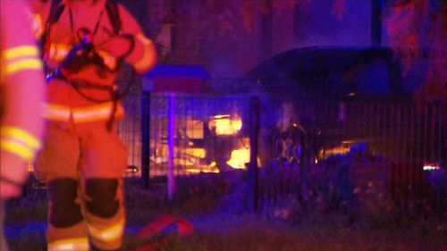 The fire swamped a car out front of the house. (9NEWS)