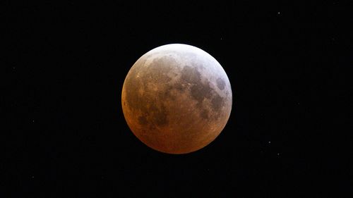 The moon is seen during a total lunar eclipse  on March 14, 2025 in Daytona Beach, Florida. 
