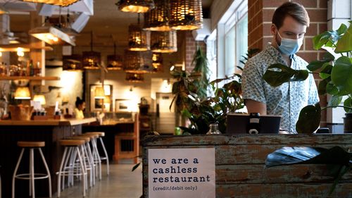 Brad Lavelle, a shift lead at Bartaco, works the front desk at the restaurant in Arlington, which uses an automated app for ordering and payments. 