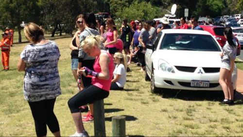 Searchers sit despondent after being told the body of Sam Trott has been found. (9NEWS)