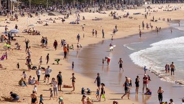 Sydneysiders enjoy the warming weather at Manly Beach.