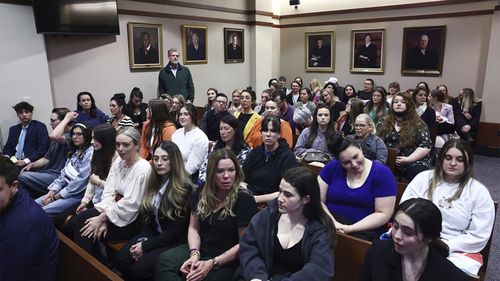Spectators fill the courtroom before the start of the day at the Fairfax County Circuit Court in Fairfax, Va.