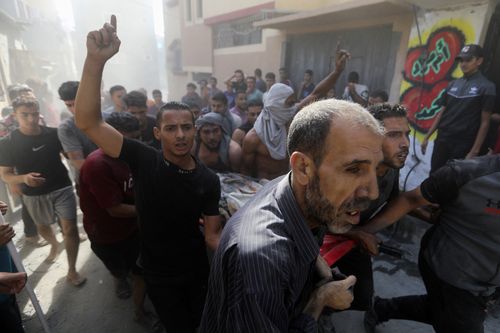 Palestinians carry a body of a dead person who was found under the rubble of a destroyed building following Israeli airstrikes on town of Khan Younis, southern Gaza Strip, Thursday, Oct. 26, 2023.  