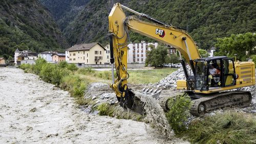 An excavator removes stones from the bed of the Navizence river, which flows into the Rhone, in Chippis, canton Valais, Switzerland.