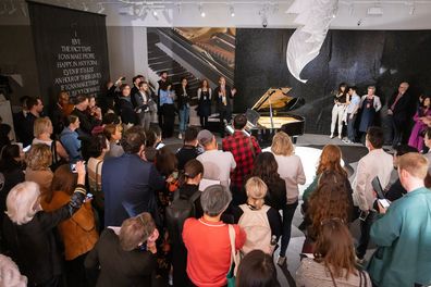 Guests view a Yamaha Baby Grand Piano owned by Freddie Mercury on display at Sotheby's on August 03, 2023 in London, England.   