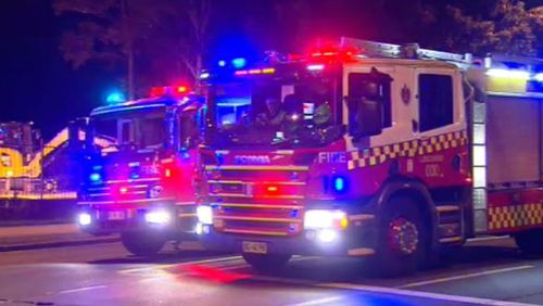 Thirty firefighters worked to bring the train fire under control tonight. (9NEWS)
