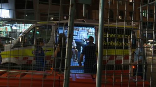 Paramedics treat an injured partygoer in Sydney's CBD.