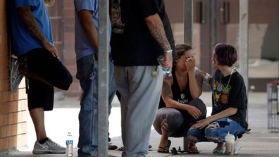 People react outside the unification center at the Alamo Gym, following a shooting at Santa Fe High School on Friday. (AP)