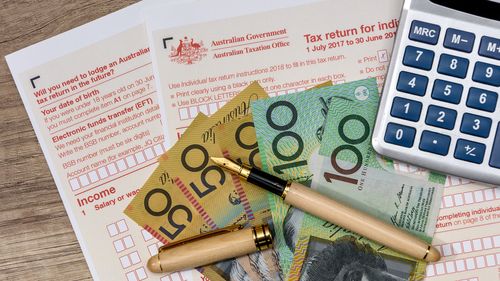 Australian dollars with calculator and tax form