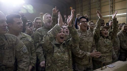Troops cheer on President Donald Trump.