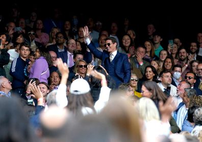 Tom Cruise (centre) waves to the fans as he watches the ladies' singles final between Ashleigh Barty and Karolina Pliskova on centre court on day twelve of Wimbledon at The All England Lawn Tennis and Croquet Club, Wimbledon. Picture date: Saturday July 10, 2021. (Photo by Adam Davy/PA Images via Getty Images)